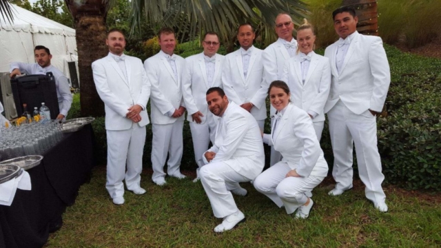Our Staff at a Wedding in white tuxedo suits